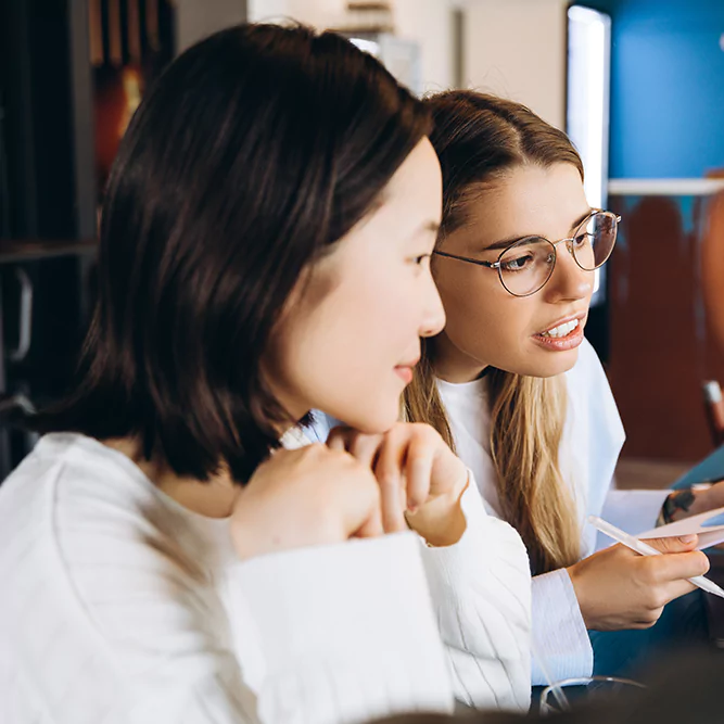 businesswomen-collaborating-analyzing-charts-in-o-2025-02-20-11-38-08-utc-67e1794d9ac5e.webp